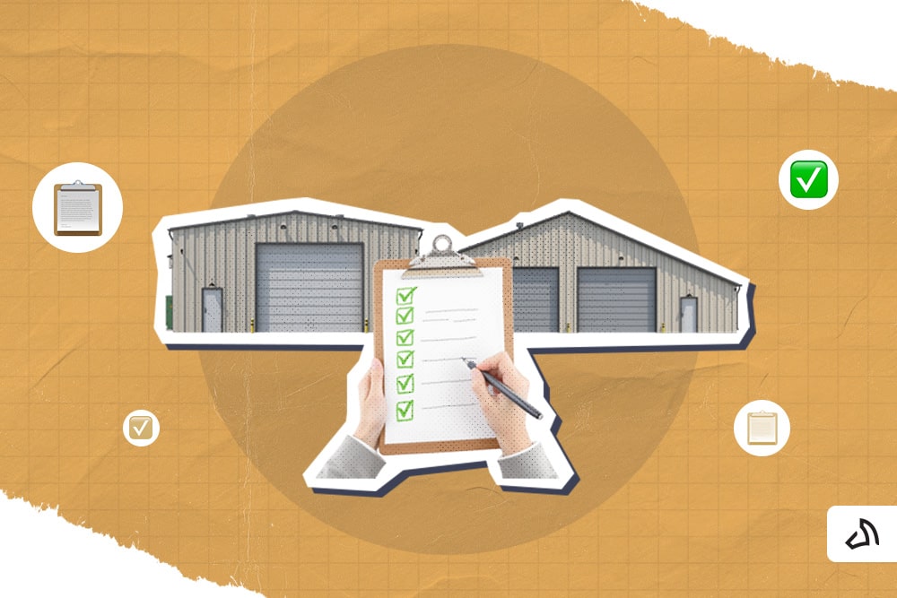 A pair of hands holding a checklist in front of two warehouses.